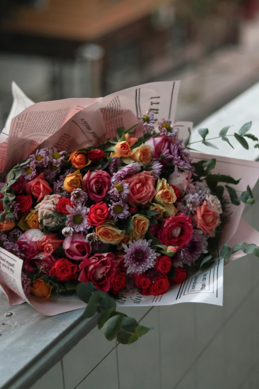 there is a bunch of flowers wrapped in pink tissue paper