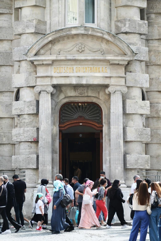 a group of people standing in front of a building