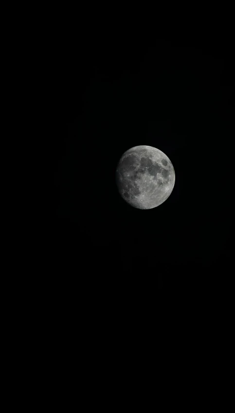 a full moon seen over the ocean with only its lights on