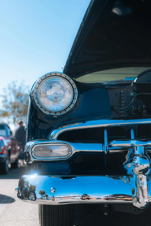 this is a closeup of the front grills and hood lights on an old classic car