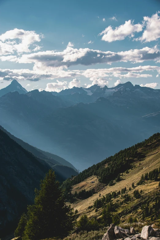 mountains can be seen in the distance while looking down on some rocks