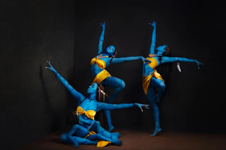 a group of girls in blue and yellow outfits