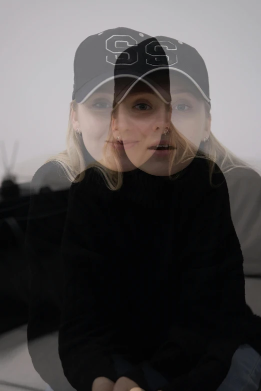 a woman is in the reflection of her hat