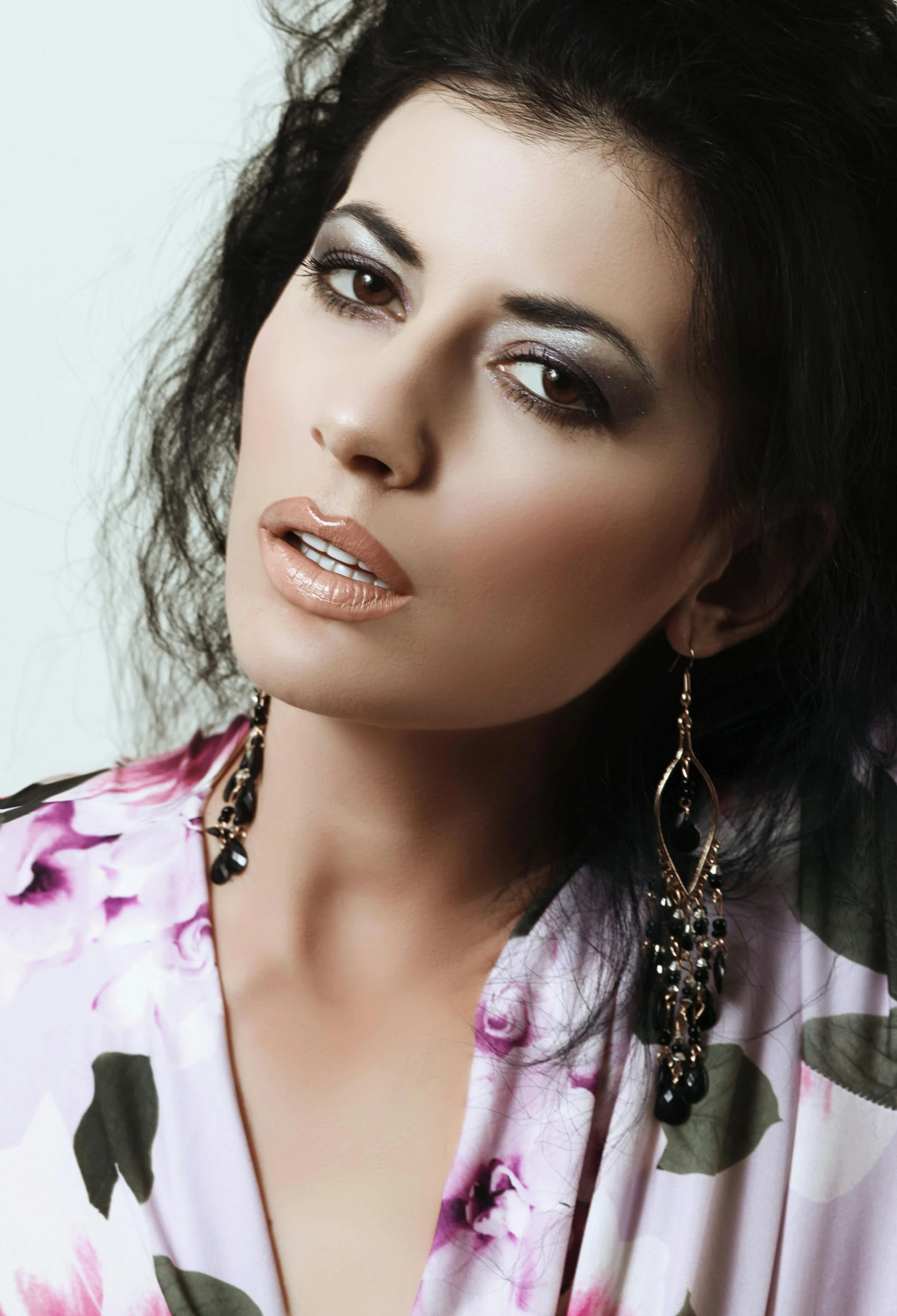 a close up of a woman wearing large earrings