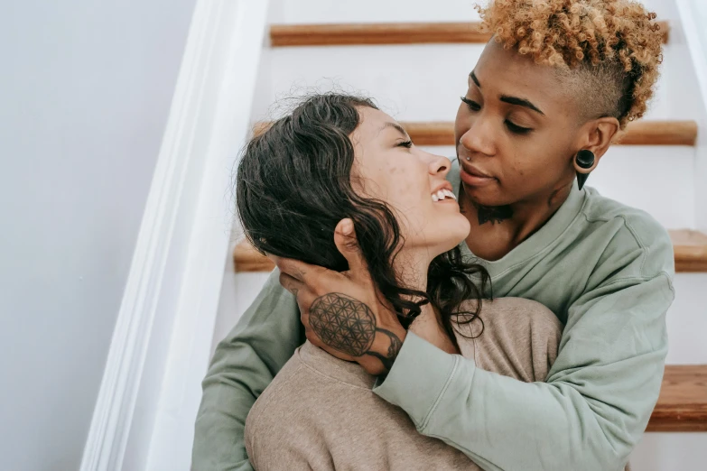 two women are emcing on the stairs of a staircase