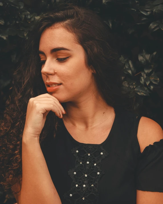 the woman is posing for a picture wearing black