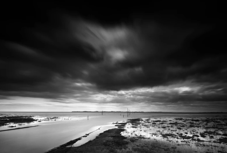 black and white pograph of an ocean in the distance