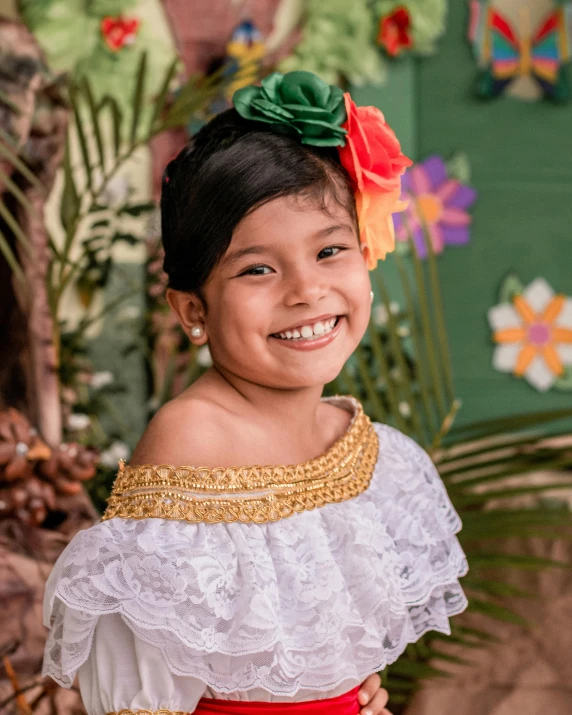 little girl with a frilly on top and green and red hair