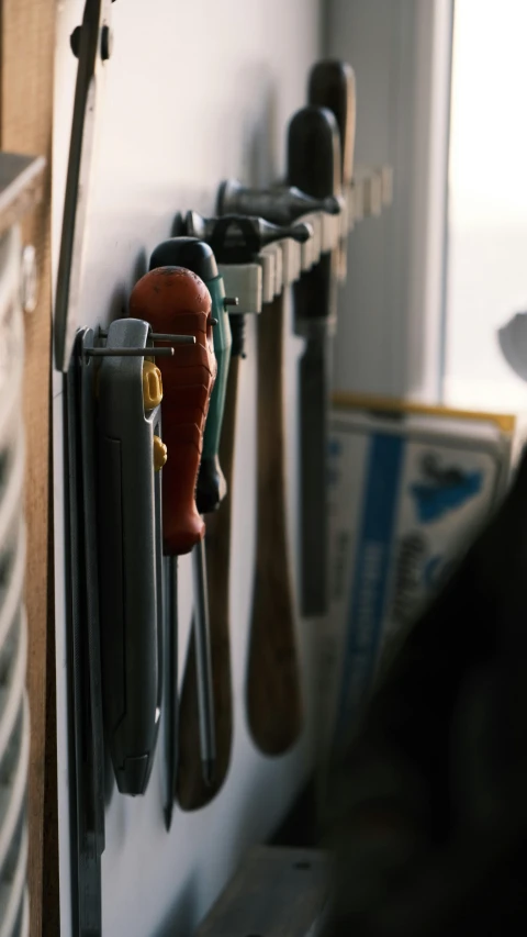 a wall mounted rack of baseball bats