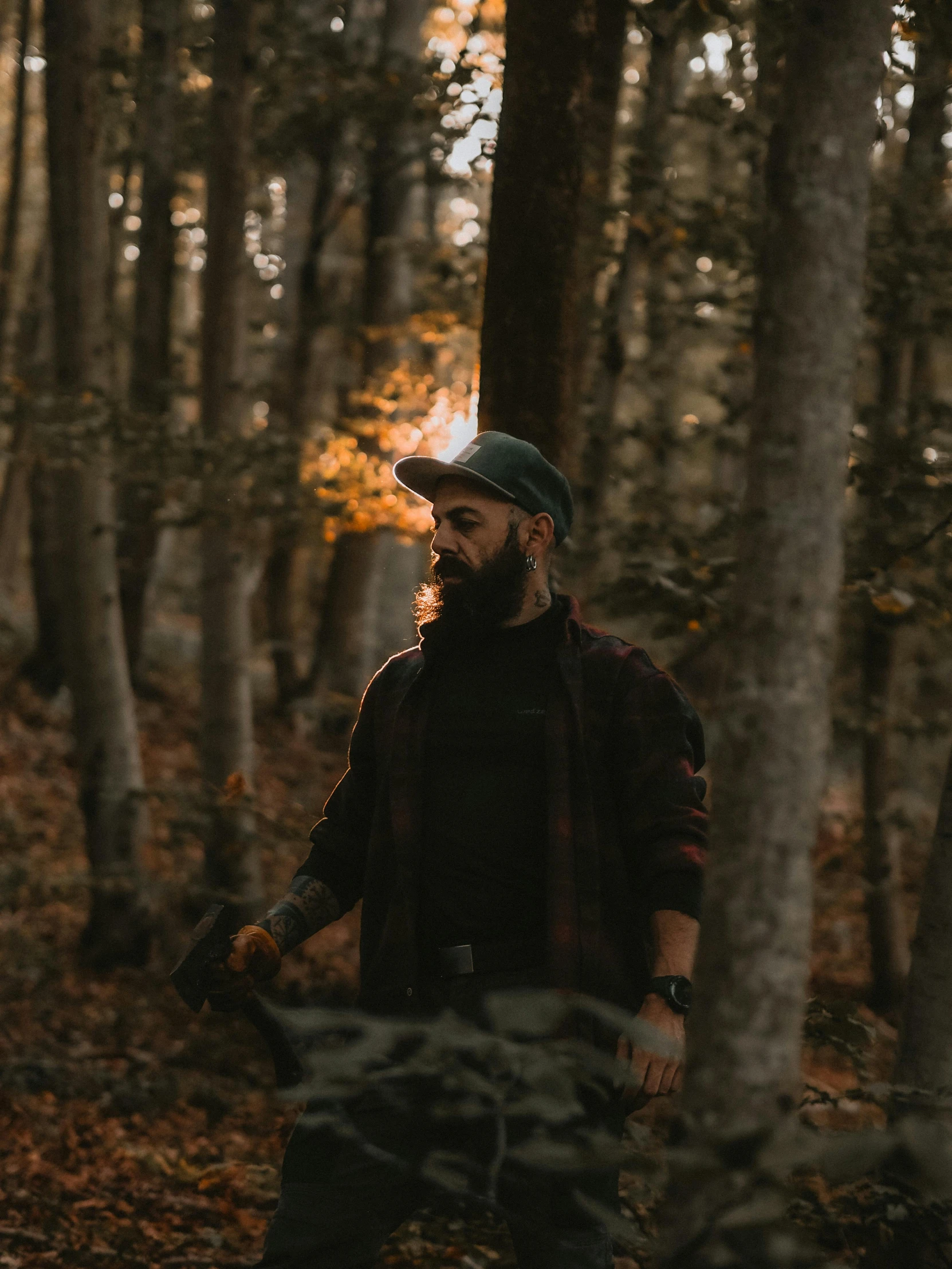 a man standing in a wooded area in autumn