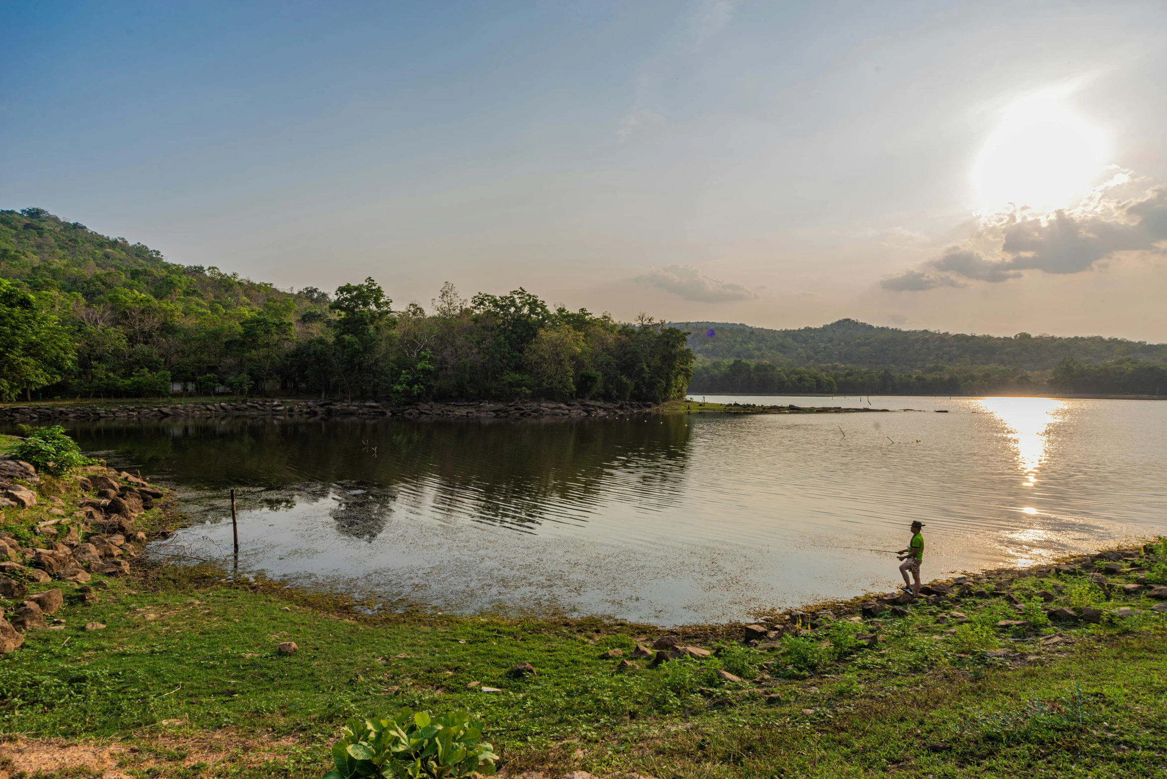 a man and his small bicycle beside a body of water