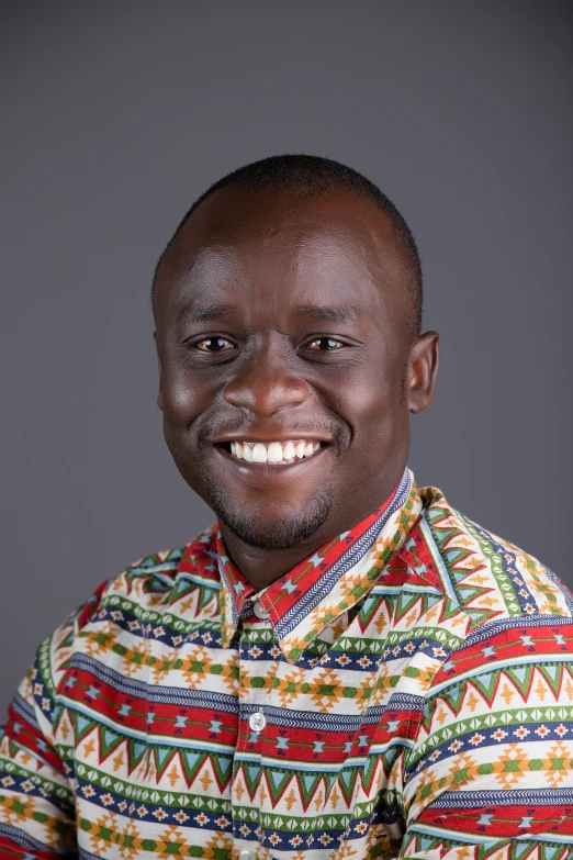 a man smiles as he poses for a pograph