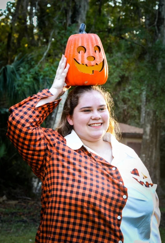 a woman in a jack - o'- lantern costume posing for a po