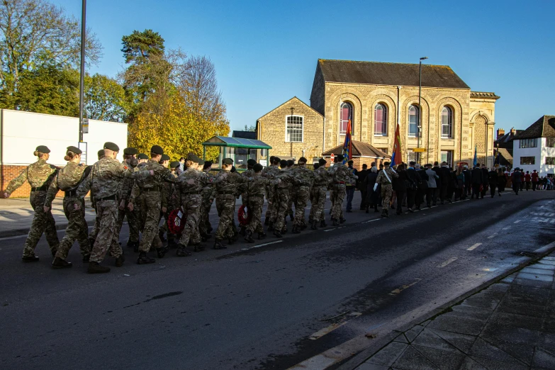 military line up with their flags in the street