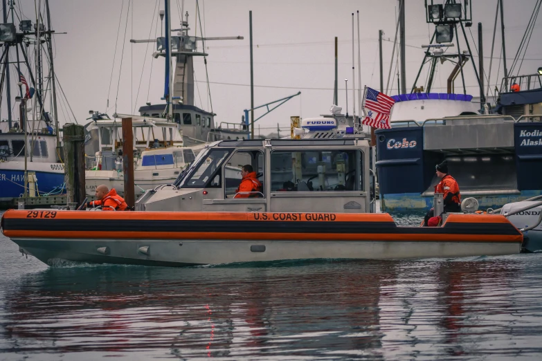 two men wearing red and blue on an orange boat