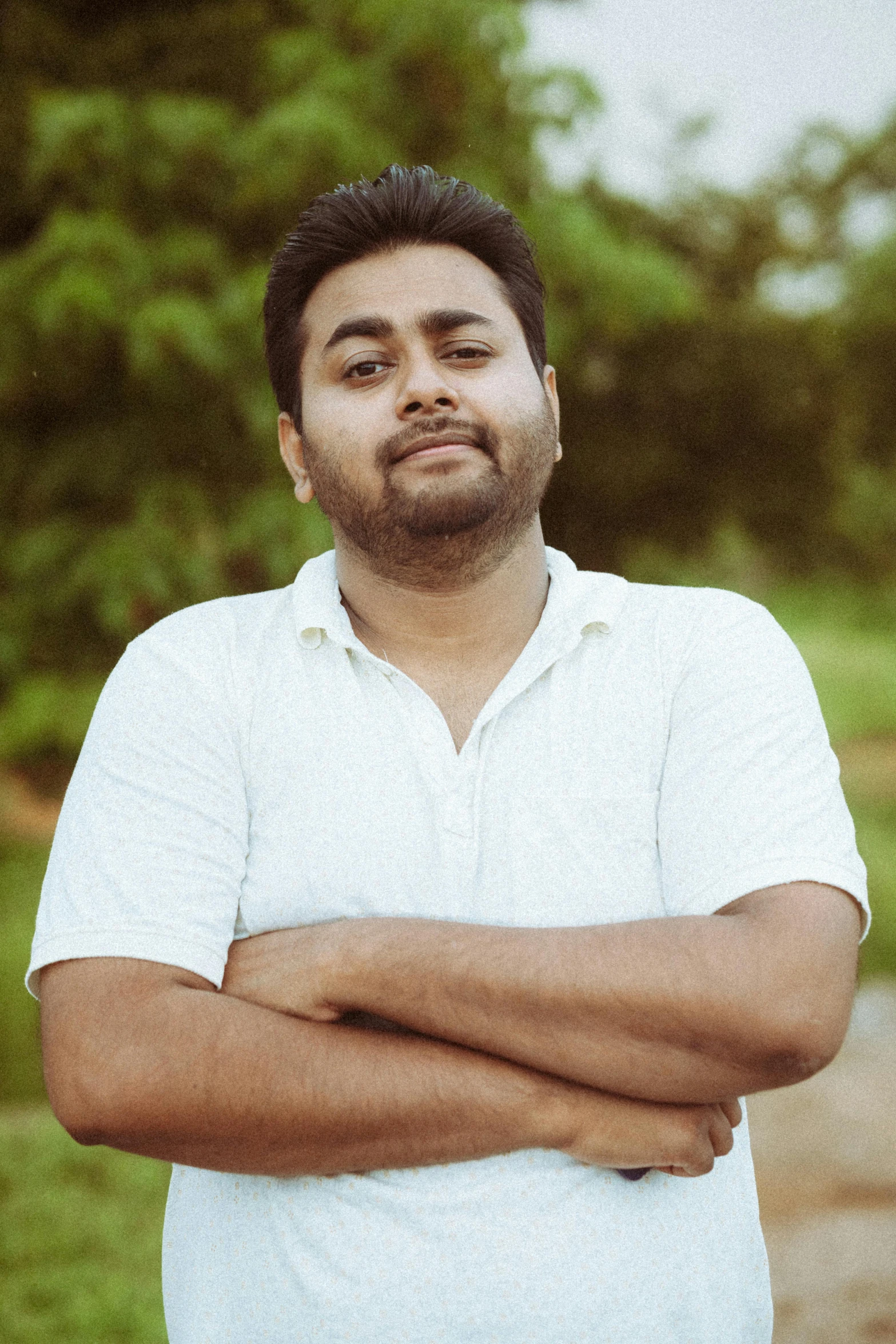 a man who is standing with his arms crossed