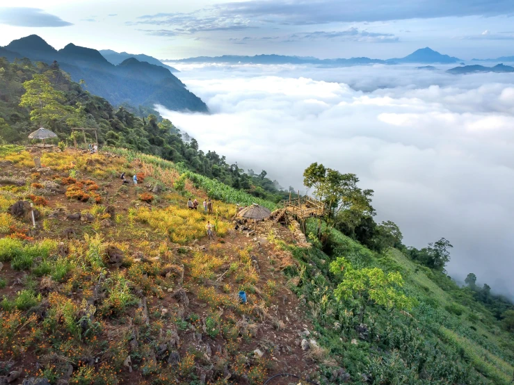 clouds in the mountains over a grassy hillside