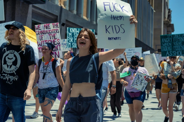 some people walking on the street protesting