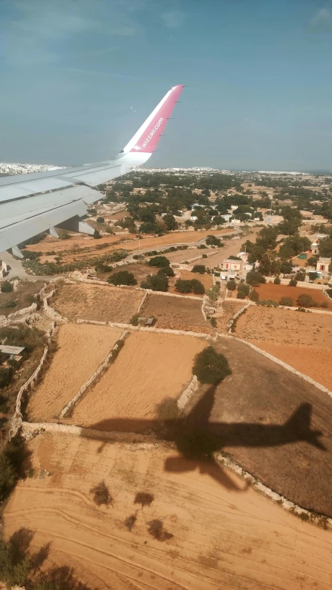 a big plane flying over a small village