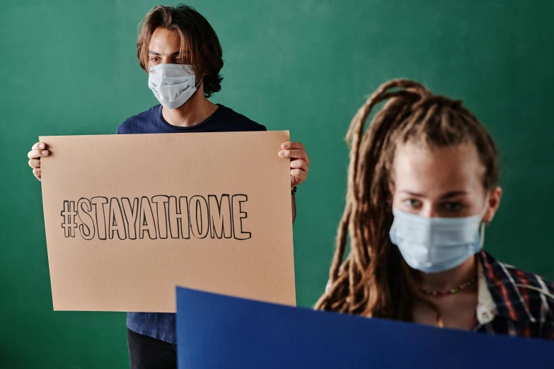 two students hold a sign that says'i want everyone to take time off '