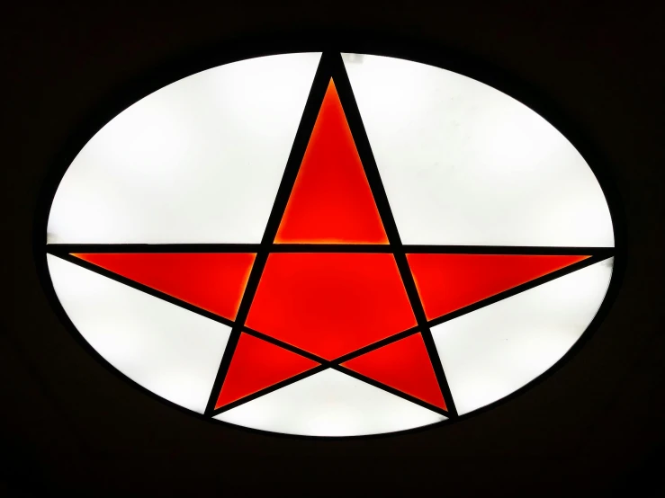 a red and white circular design in the dark