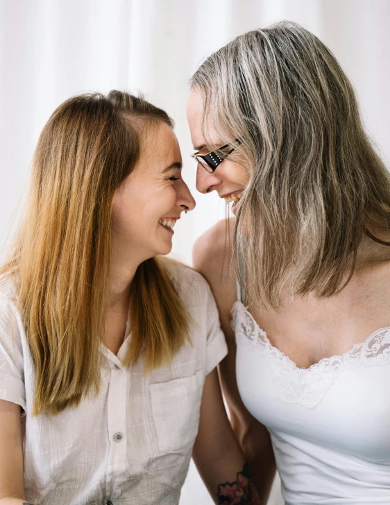 two beautiful women smiling together while they laugh