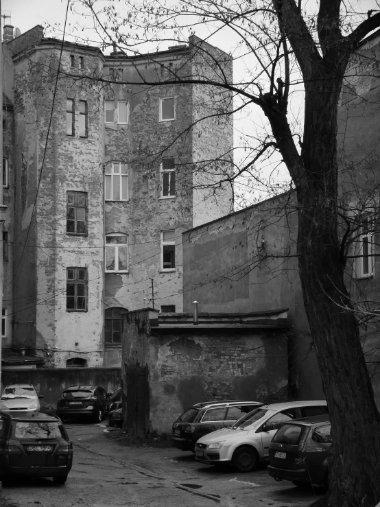 several cars parked in front of an apartment building