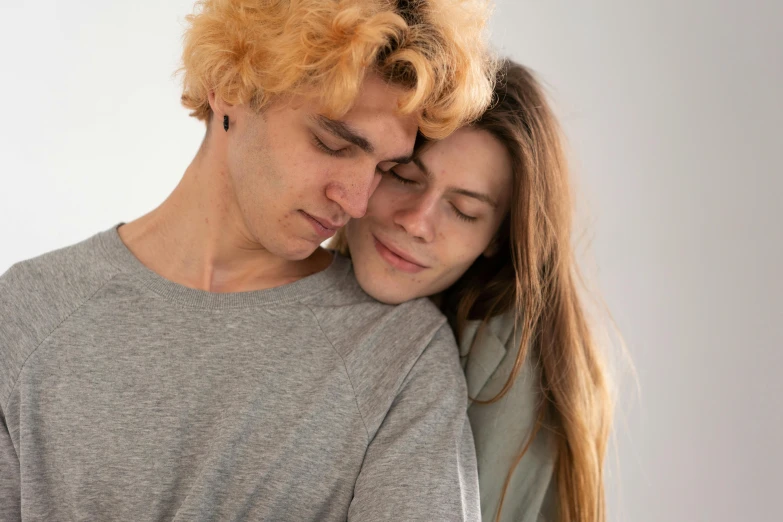 a man with his head on a woman's shoulder