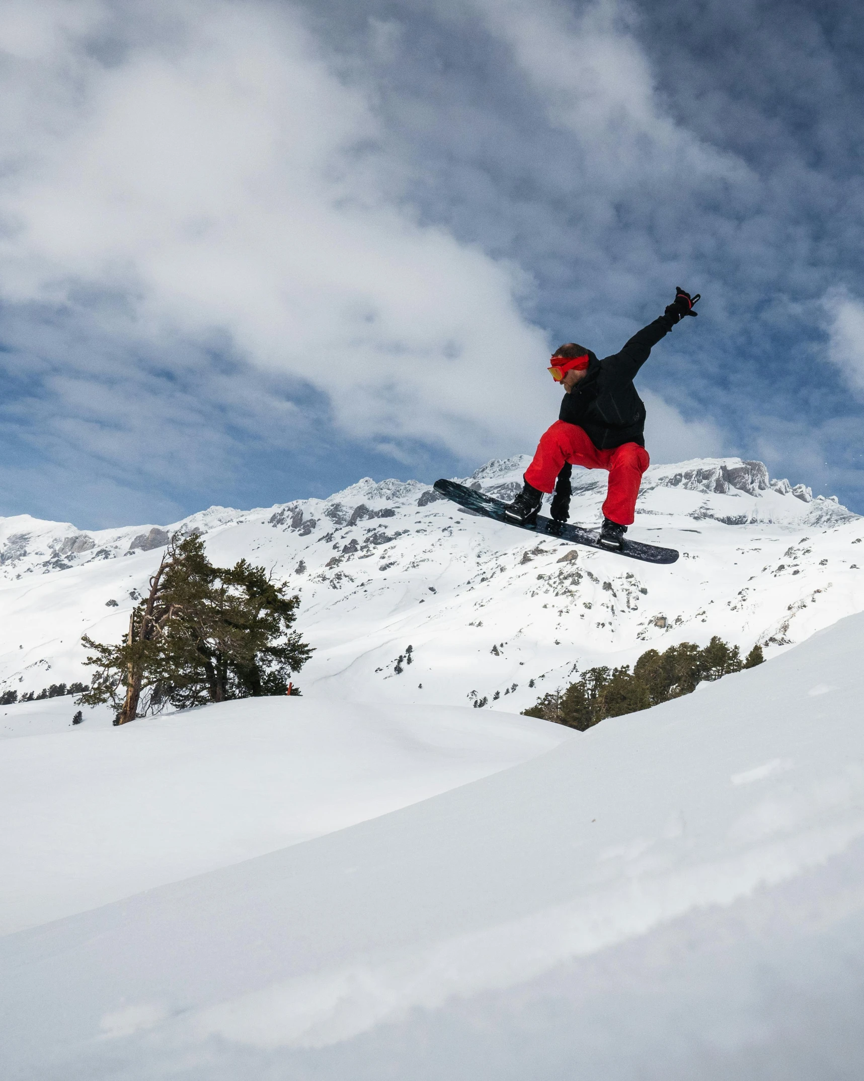 snowboarder performing an aerial trick on mountain top