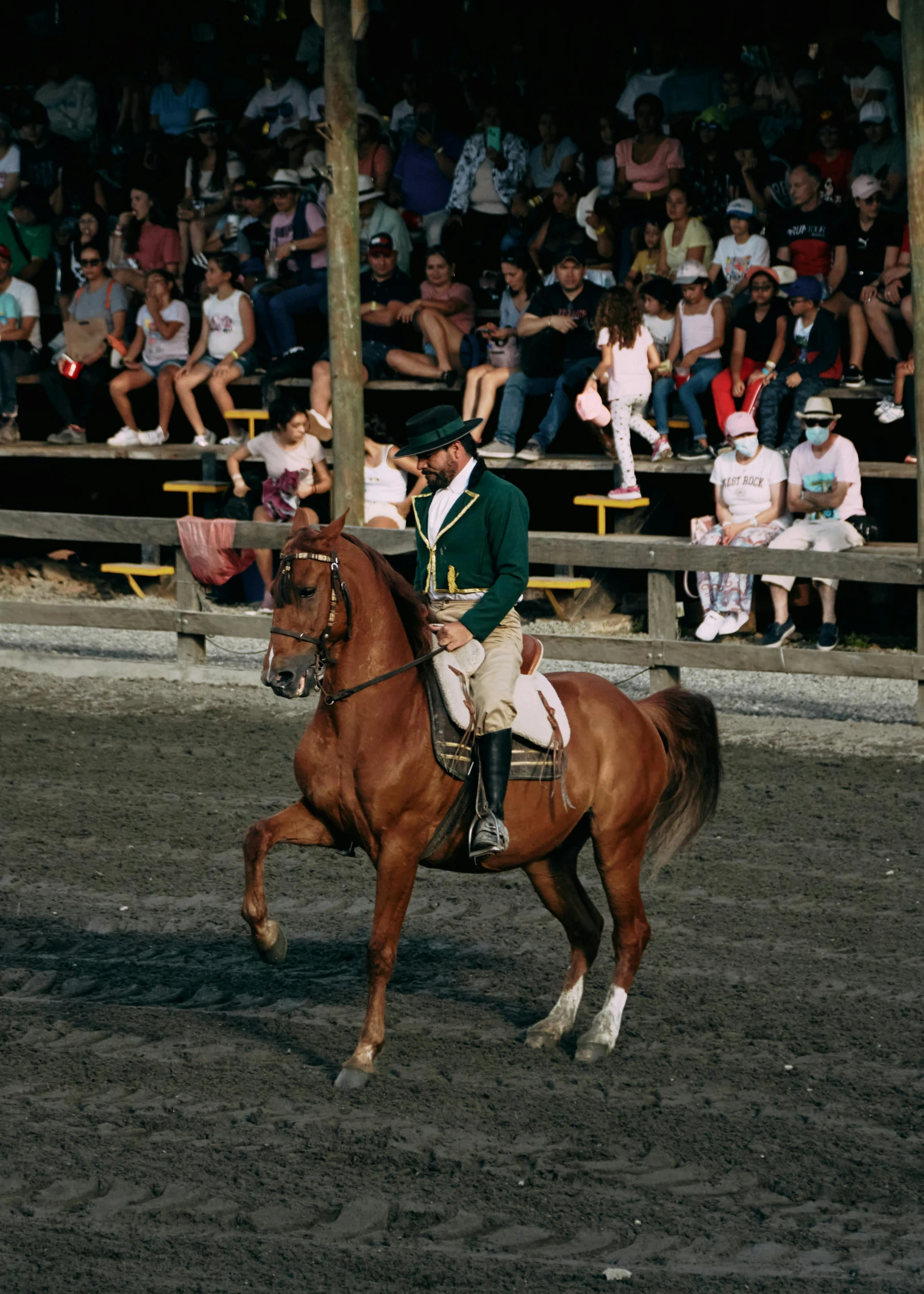 a man dressed in green riding on the back of a horse