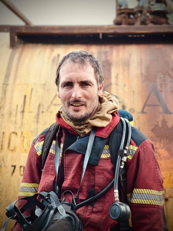 a man in a fire suit wearing a camera