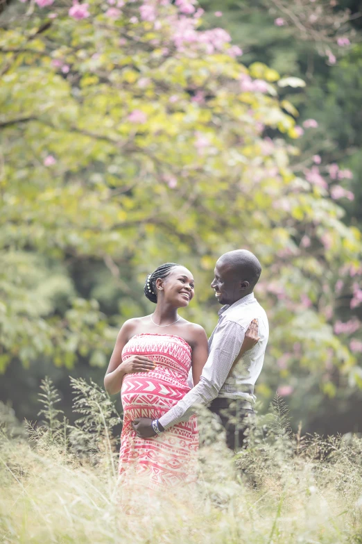 a man and woman laughing in tall grass