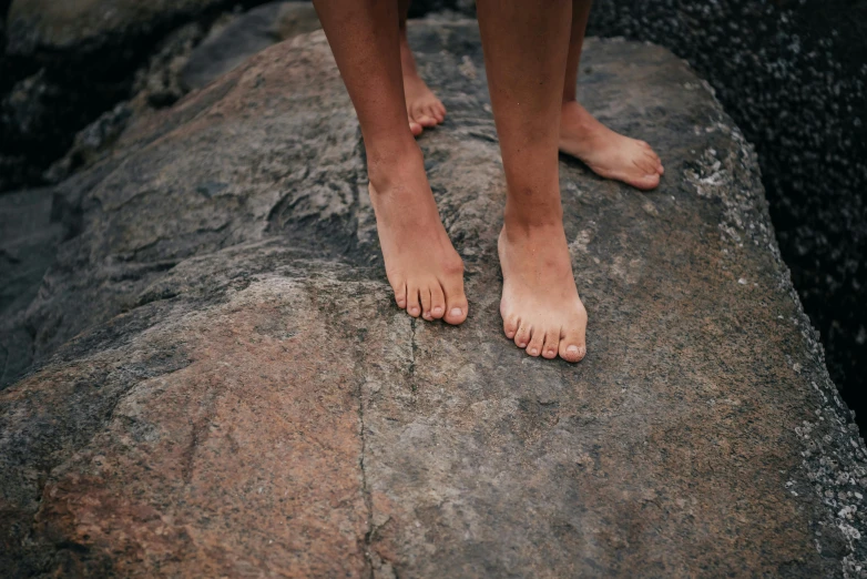 a person standing on top of a large rock