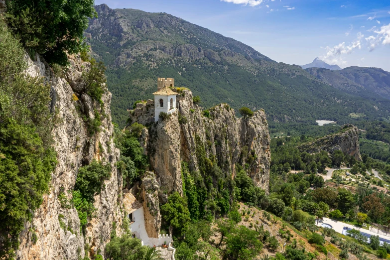 an image of a mountain side with a church on top