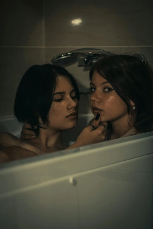 two women looking at each other in the tub