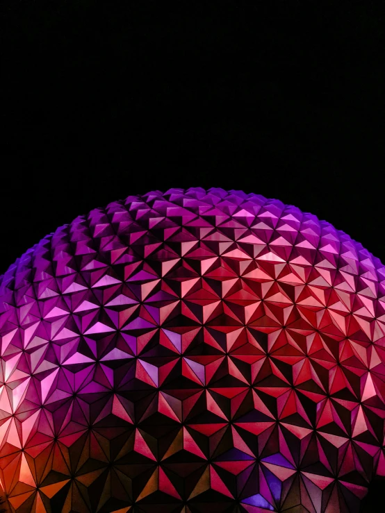 an elaborate lit flower of life is seen at night