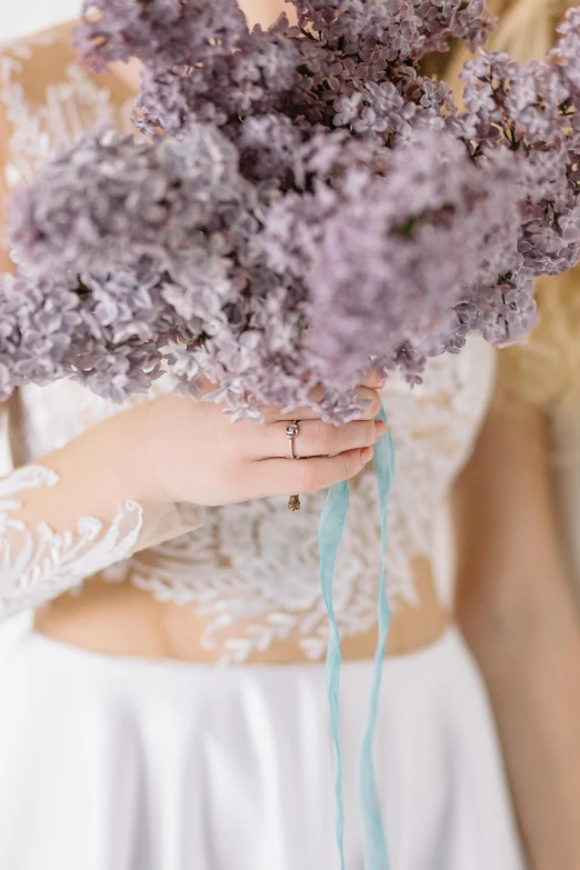 bride holding lavender flowers in hand