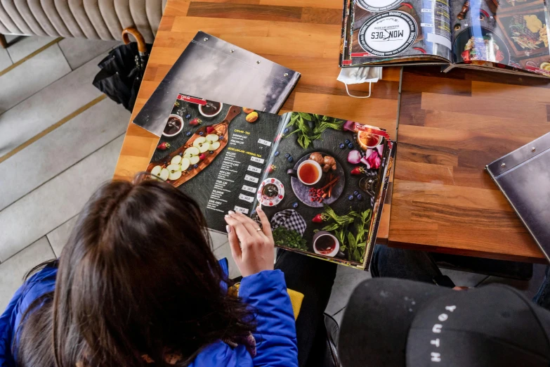 woman sitting at a table working on a recipe