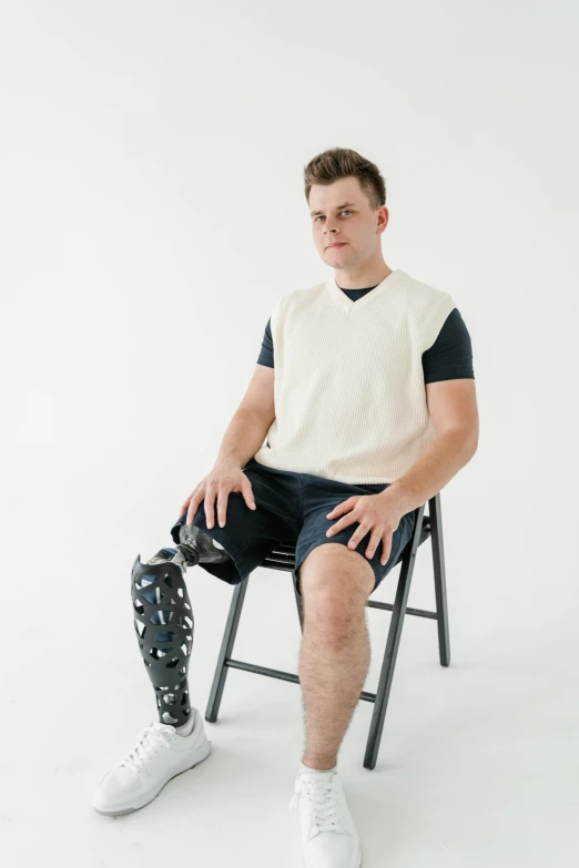 there is a male sitting on the chair and posing for a picture