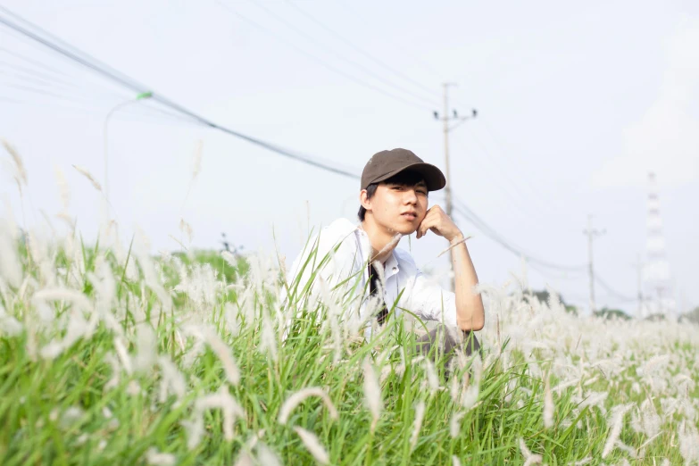 a man in a baseball cap sitting on the ground