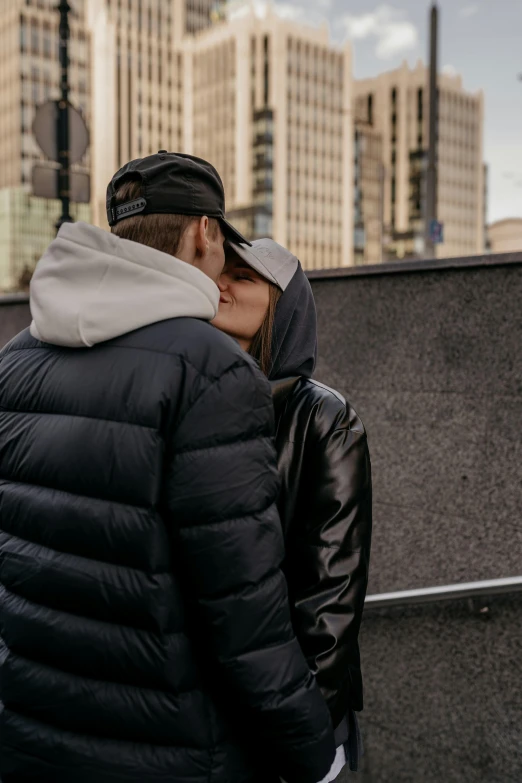 a man and woman that is kissing each other