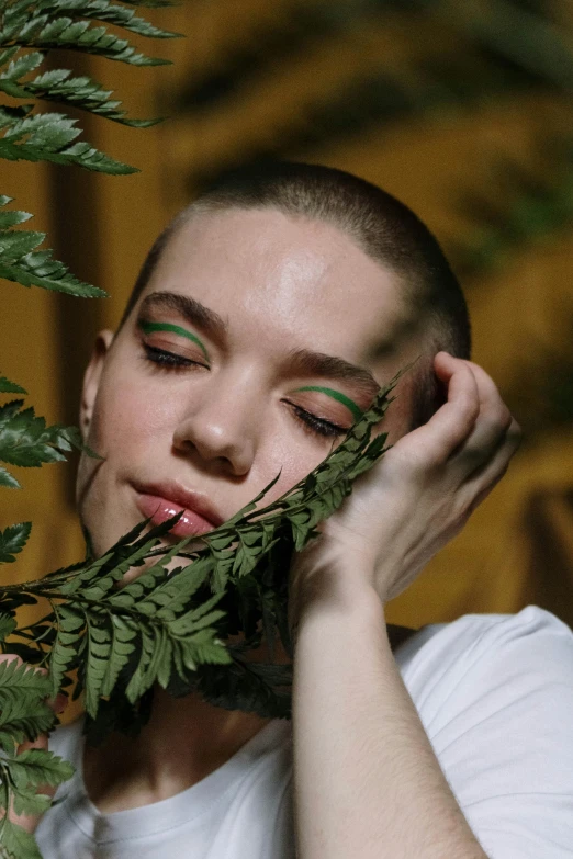 woman with greenery in front of her face