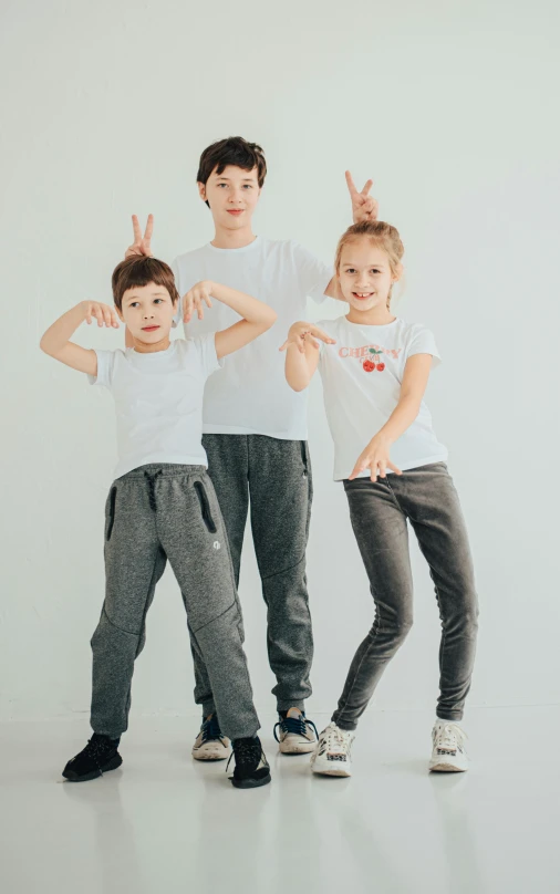 three s are wearing matching outfits while posing for the camera