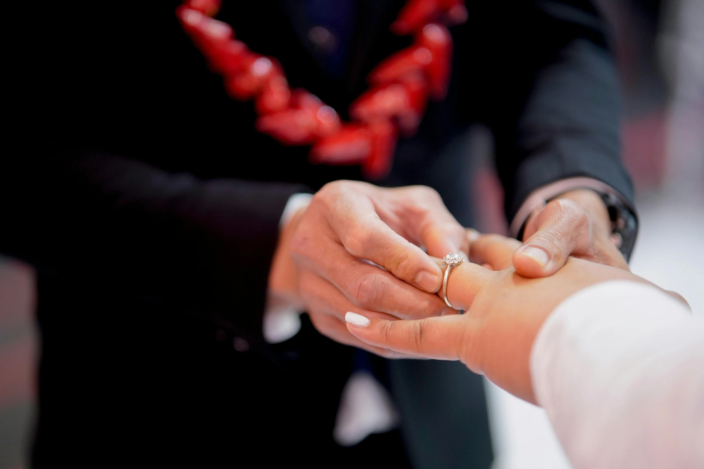 a man and a woman exchanging a wedding ring