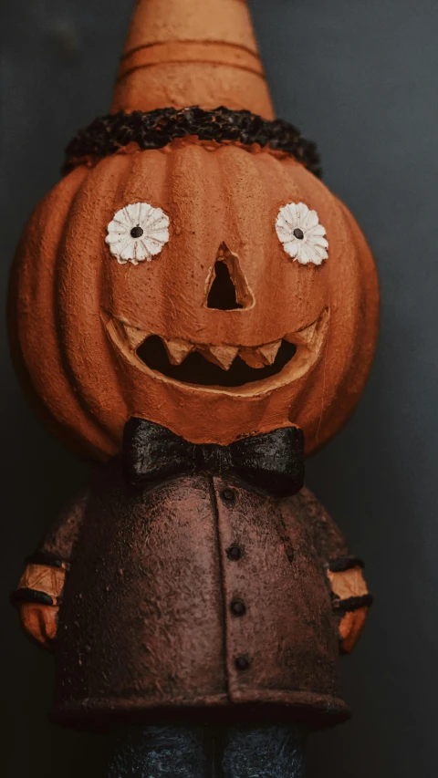 a carved pumpkin with a hat and bow tie