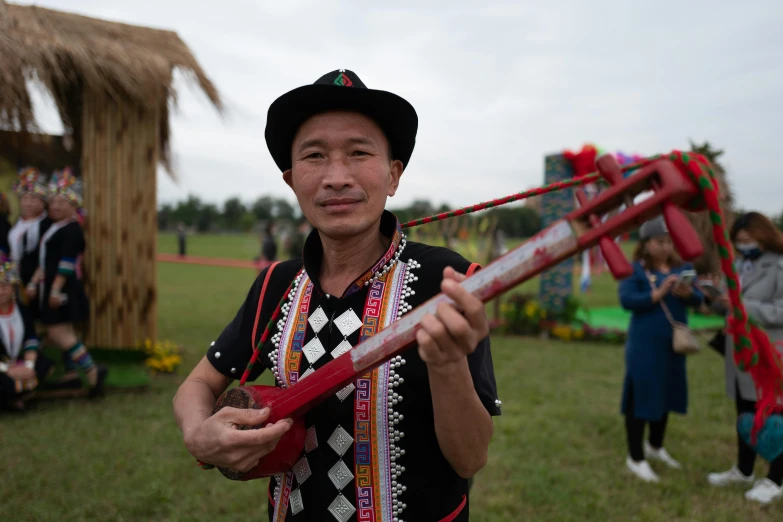 a man holds onto two red objects in one hand