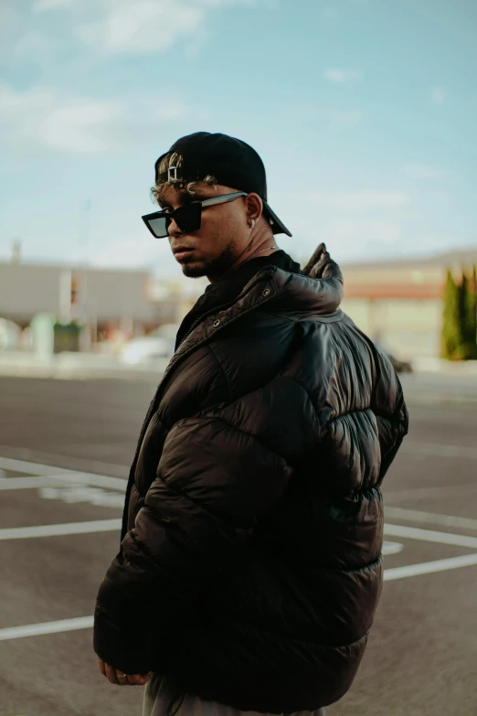 a man standing next to a parking lot