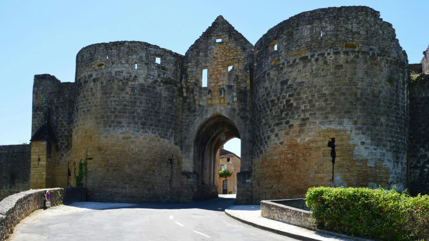 an open entrance to a castle with a cross at the top