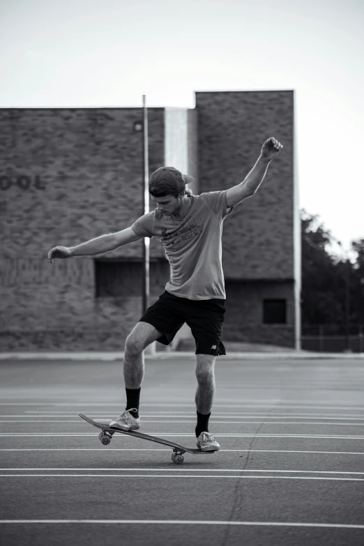 man riding his skateboard across a tennis court