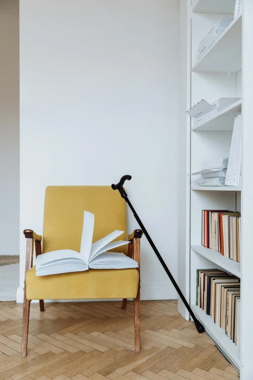 a yellow chair with an open book on top of it